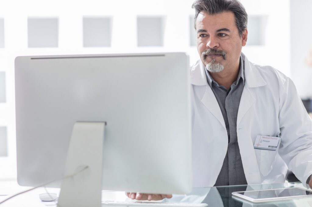 Male doctor working at computer